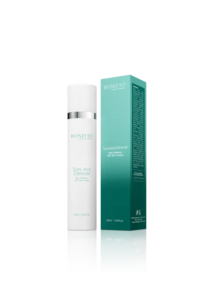 A bottle of BONITTO Sun Age Defense SPF 30+ sunscreen stands next to its teal and white product box, both reflecting on a shiny surface.